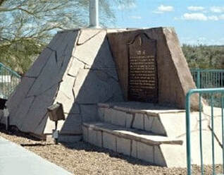 A snapshot of a flagstone structure with flagpole and marker.