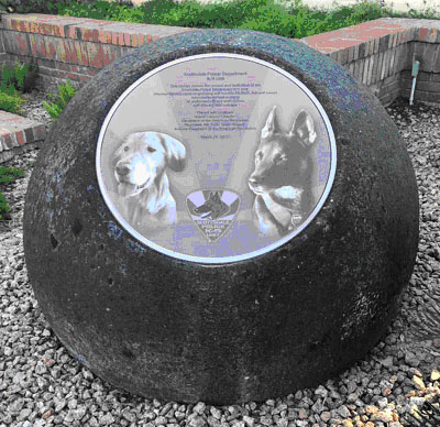 A spherical stone about three feet in diameter with a circular plaque. Text is not distinguishable. Honors the Scottsdale K-9 unit.