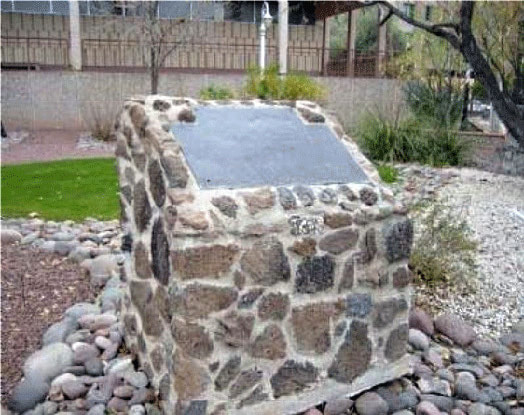 A snapshot of a concrete and stone marker base with a plaque situated in river rock. Marker text is in the body of this page. Second entrance to the Spanish Presidio.