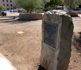 A snapshot of a stone marker with plaque.