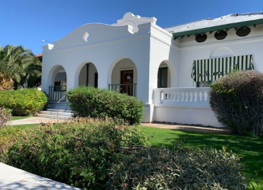 Snapshot of a late 19th century or early 20th century house with an arched facade.