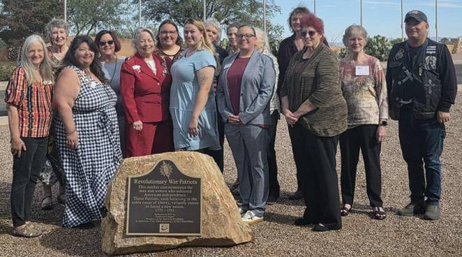 A photo showing fifteen members of the Tombstone Chapter standing behind the newly dedicated marker along with Honorary ASDAR State Regent, Sallie Lovorn.
