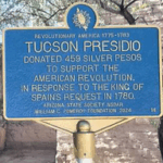 A photo showing the blue plaque, which explains the 459 silver pesos donation, which was at the request of the King of Spain in 1780 to support the American Revolution.